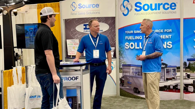 Photo of people visiting the Source booth, 826, during the M-PACT Fuel & Convenience Tradeshow.