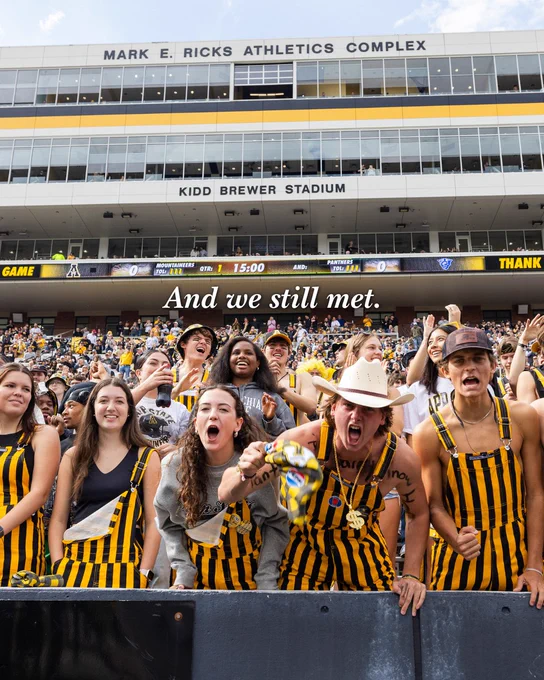 App State fans cheering in the stands during a football game at Kidd Brewer Stadium.