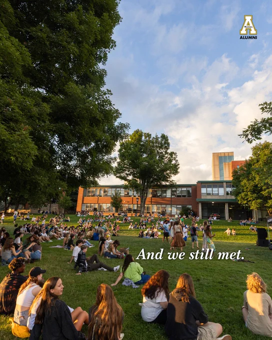 App State students gathered on Sanford Mall lawn in front of campus buildings on a sunny afternoon.