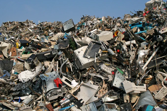 Large pile of trash under a blue sky. 