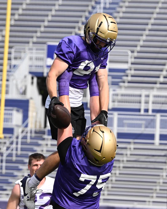 Wyatt Maines lifts up Chase Pensyl during Thursday's practice.