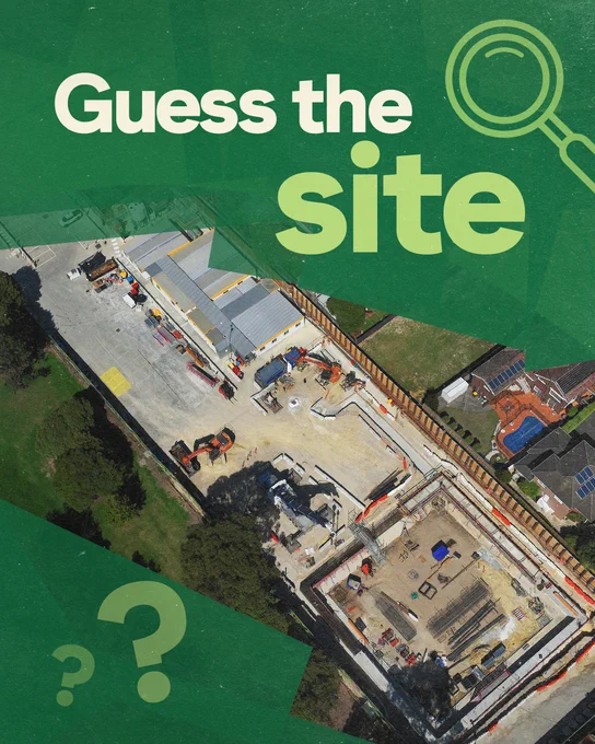 Aerial view of a Suburban Rail Loop construction site with buildings and equipment, surrounded by greenery. The words "Guess the site" are prominently displayed on the image, along with several question marks.