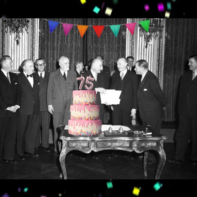 A black-and-white photo of the signatories of the Treaty of Paris, from left to right: Paul van Zeeland, Belgian Minister for Foreign Affairs; Joseph Bech, Luxembourg Minister for Foreign Affairs; Joseph Meurice, Belgian Minister for Foreign Trade; Carlo Sforza, Italian Minister for Foreign Affairs; Robert Schuman, French Minister of Foreign Affairs; Konrad Adenauer, German Federal Chancellor; Dirk Stikker, Dutch Minister for Foreign Affairs; And Johannes van den Brink, Dutch Minister for Economic Affairs. The picture is from 1951 but there is a cake sticker with a ‘75’ candle on top, and colourful bunting sticker hanging above. 