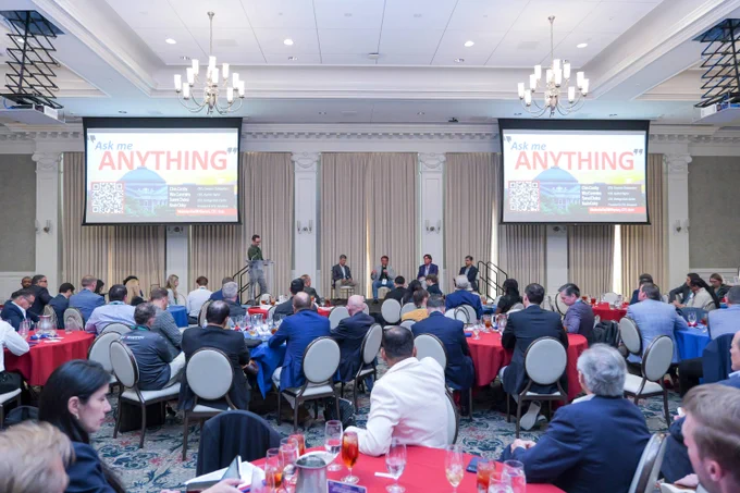 A wide shot of the room with a view of the panel speakers during the Ask Me Anything discussion at the Summit