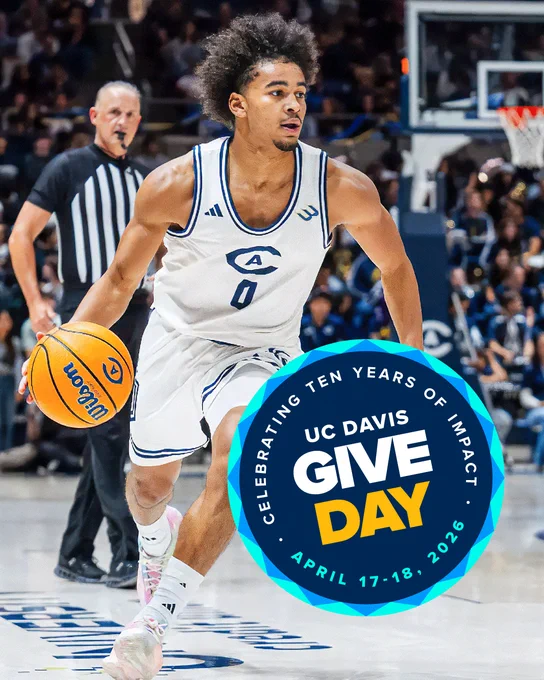 A basketball player from UC Davis dribbles on the court during a game. The foreground features a circular graphic promoting "UC Davis Give Day: Celebrating Ten Years of Impact, April 17-18, 2026." Spectators are visible in the background.