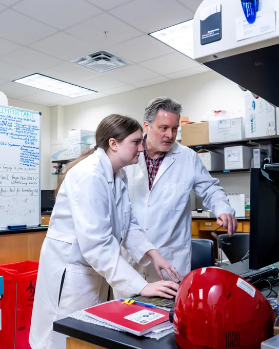 Dr. Mark DeCoster and Jenna Etheridge doing research in the lab  