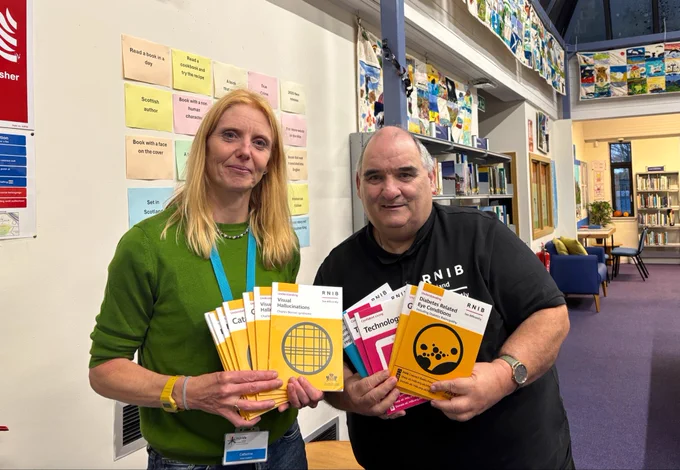 Ian right & Sarah library assistant left  with information brochures   Now available in all highland  libraries