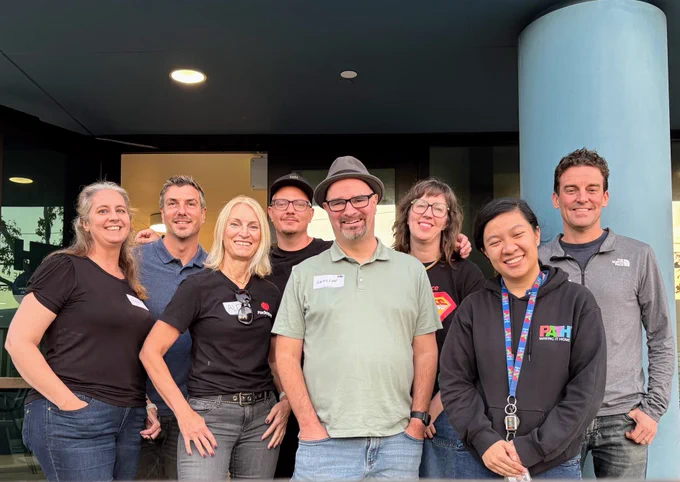 Group photo with eight individuals smiling. 