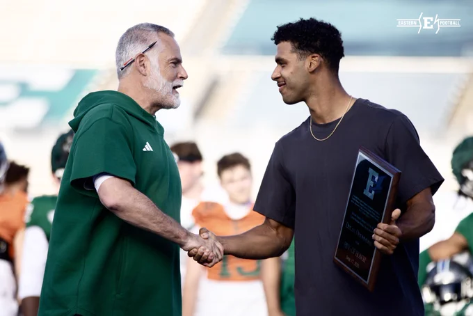 Dylan Drummond accepts his Ring of Honor plaque from Head Coach Chris Creighton