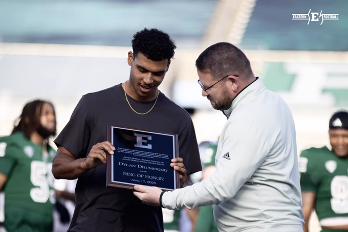 Dylan Drummond accepts his Ring of Honor plaque from Athletic Director Scott Wetherbee