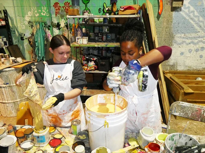 Two individuals working at a service project during Beyond Bama. 