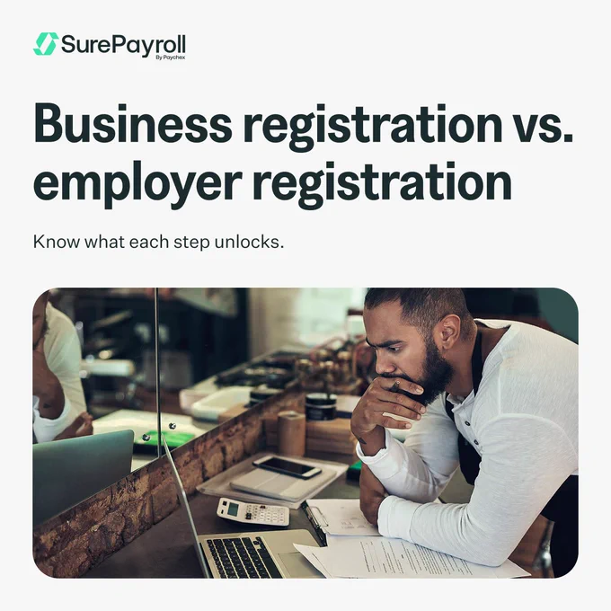A person sits at a desk with a pen and paper, appearing focused. The desk has a calculator and a computer. The text reads: "Business registration vs. employer registration. Know what each step unlocks." The logo for SurePayroll by Paychex is visible in the corner.