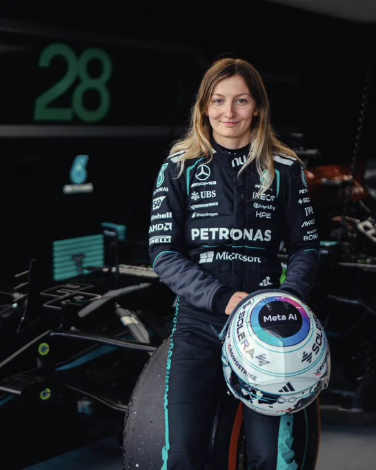 Doriane Pin in her Mercedes F1 race suit sat on the wheel of the Mercedes W12 at Silverstone