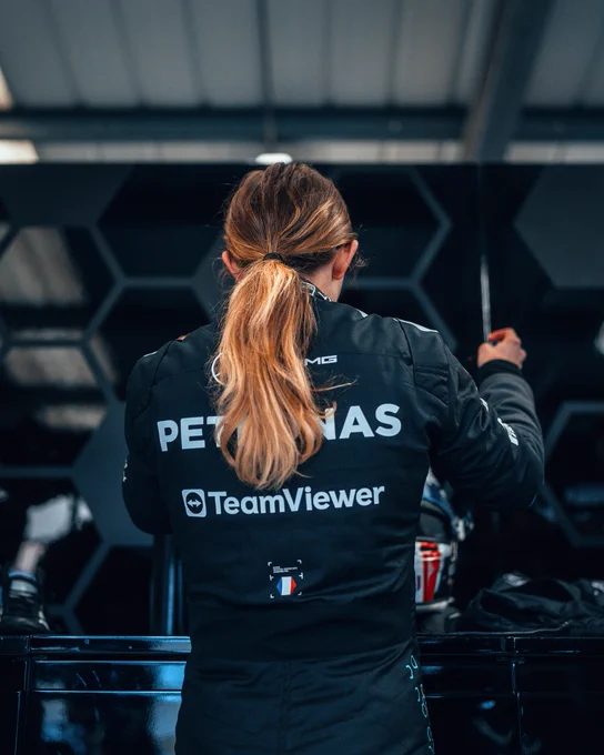Doriane Pin suiting up with her ponytail falling down the back of her suit.