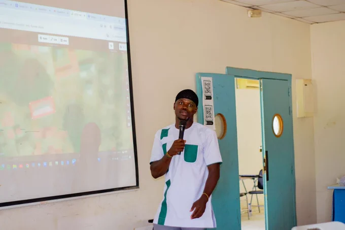 This picture shows Abdul-Fatawu Yakubu, UBIDS YOUTHMAPPERS president, dressed in white and delivering a presentation on how to edit in OpenStreetMap using the iD editor at the First General Meeting at Spanish Lab on April 11, 2026