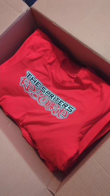 A box of red t-shirts with The Spriters Resource logo