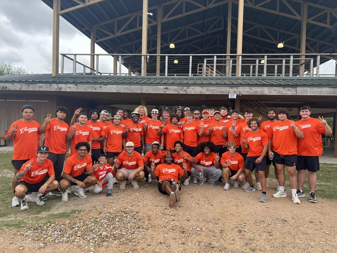 UTRGV football players wearing orange shirts volunteering at Camp Rio in Brownsville, spending time with children and families from the Moody Clinic. Activities include group photos, helping kids into canoes, paddling on the water, and interacting with families under a covered picnic area in a positive, community-focused environment.
