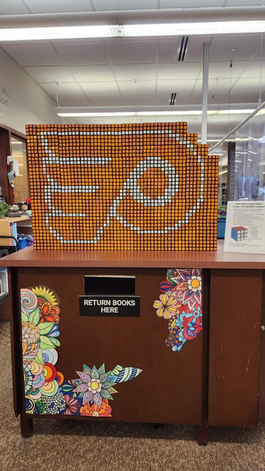 Flyers logo made form 210 Rubik's Cubes on the library return desk