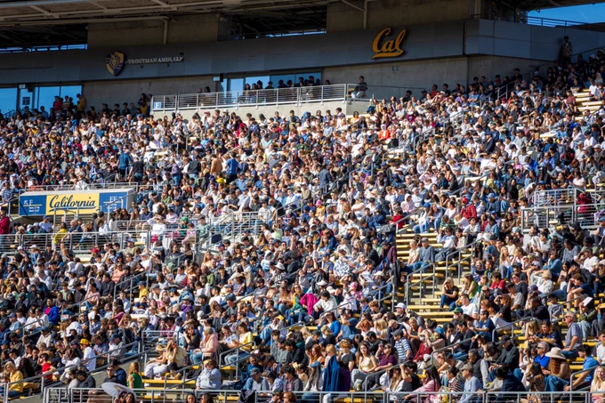 A large gathering of newly admitted students and their registered guests sitting in memorial Stadium on a sunny Cal Day.