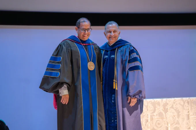 Dr. Obaid (Left in black and blue regalia), standing next to Dr. Poras Balsara (right in blue regalia) after receiving his award.