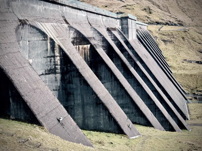 Side view of the dam. Hail collected at the foot of the concrete slope.