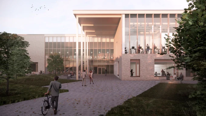 Modern building entrance with large glass windows and people walking and cycling on a paved path surrounded by greenery.