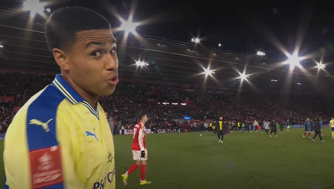 A screenshot of Shea Charles looking at the camera following the full time whistle and puffing his cheeks out.