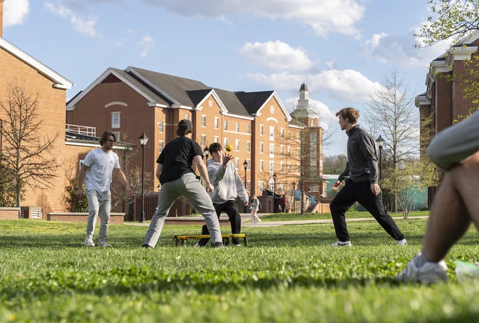 Students playing a yard game on the lawn 