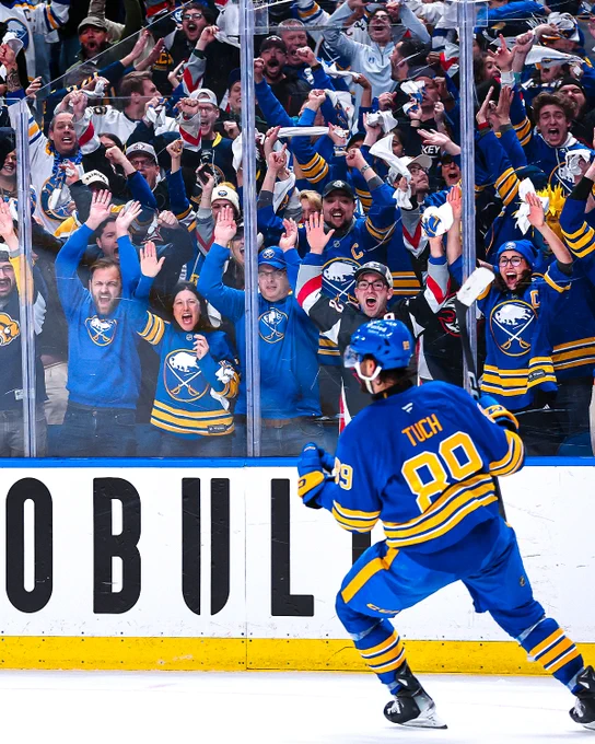 Photo of Alex Tuch in a Buffalo Sabres uniform celebrating a goal in front of the crowd