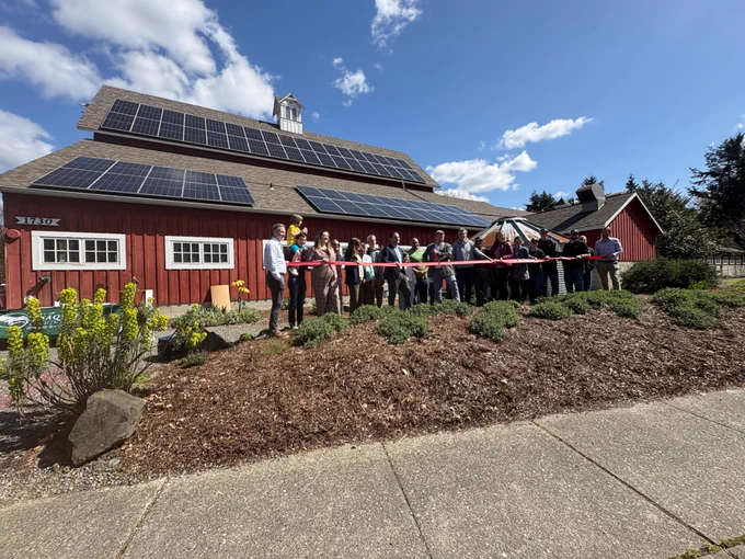 Solar Panels on Pickering Barn roof along with group attending ribbon cutting