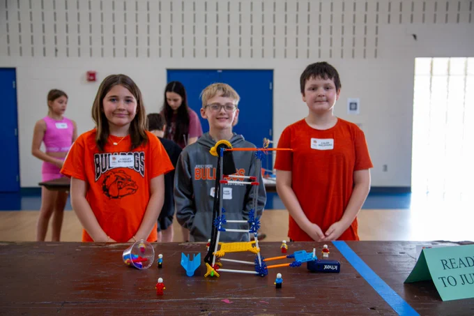 Photo of students and their KNEX creation.