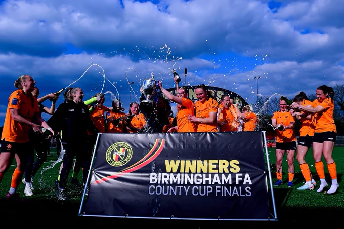 Rugby Borough Women celebrate lifting the trophy.