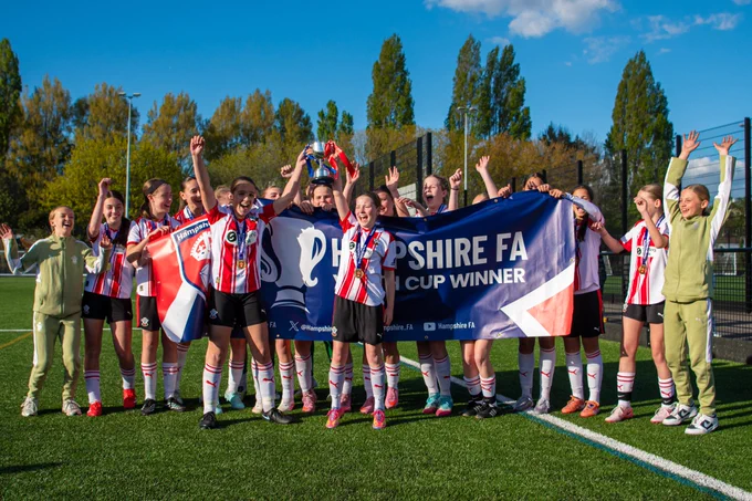 Southampton FC Women's Under-14s players celebrate with Hampshire FA Under-14 Girls Cup trophy and medals