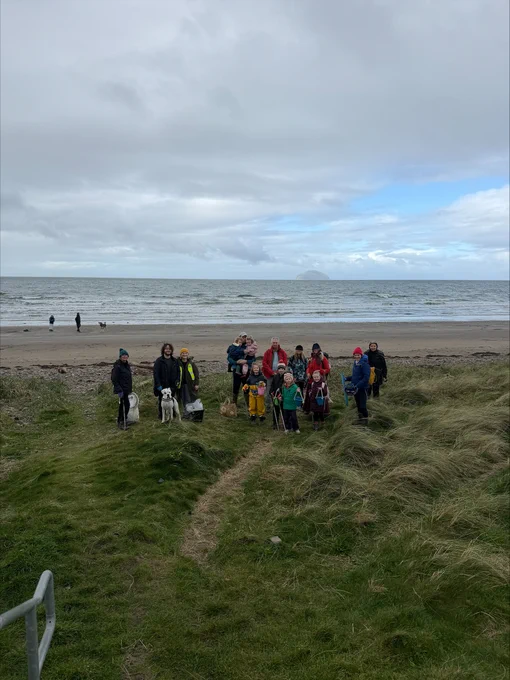 Walkers stop for a photo on Girvan beach.