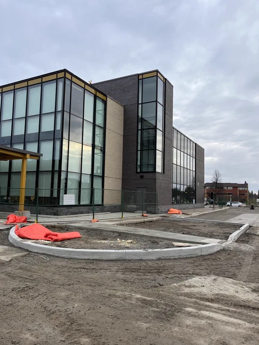 Completed facility built by PCL Construction featuring modern glass curtainwall and masonry exterior, representing final project delivery.