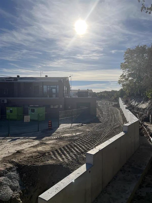 PCL Construction active jobsite showing early-stage earthwork and site preparation with graded surfaces and surrounding infrastructure development.