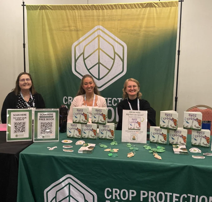 Picture of people at trade show booth. 