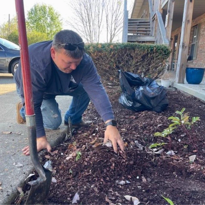 Delta employee gardening as part of their Essential Earth Day volunteer event.