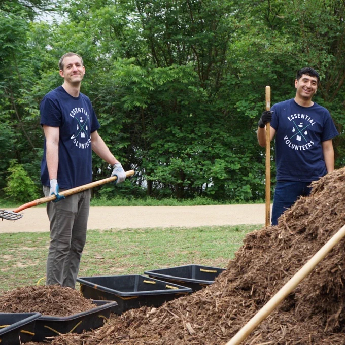 Aqua Texas employees shoveling mulch as part of their Essential Earth Day volunteer event.