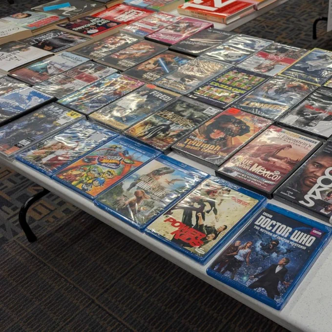 DVDs and blurays on a white table.