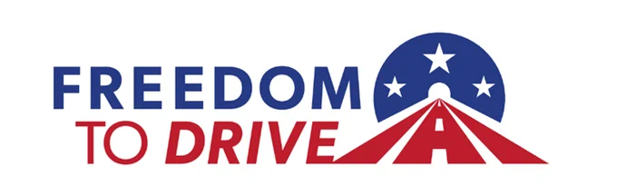 The image displays the logo for "Freedom to Drive." It features a stylized design resembling a road leading into a tunnel with stars above it, incorporating the colors red, white, and blue.