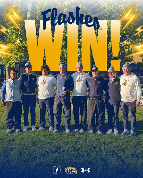 The Kent State Herb Page men's golf team poses together on a grass field after winning the Muirfield Shootout, wearing matching grey knit beanies and Kent State apparel in navy and white with gold "Flashes" lettering and golden eagle logos. The player in the center holds a clear glass championship trophy. Behind them, a wooden pavilion and trees are visible in warm late-afternoon light. A bold gold "Flashes WIN!" graphic with lightning bolt accents overlays the top of the image. The Ohio lightning bolt logo, Kent State athletic mark, and Under Armour logo are arranged at the bottom.

