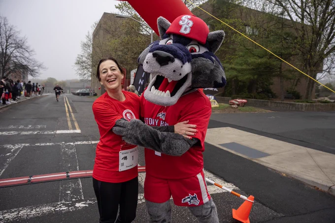 I am hugging Wolfie at the finish line of the 5k walk/run on campus. 