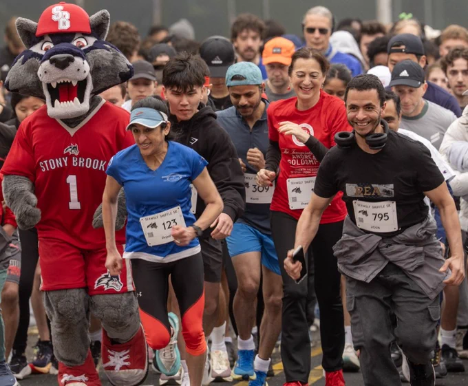 I am running with Stony Brook University community members and Wolfie at the 5K run/walk outside of the Union Hall. 