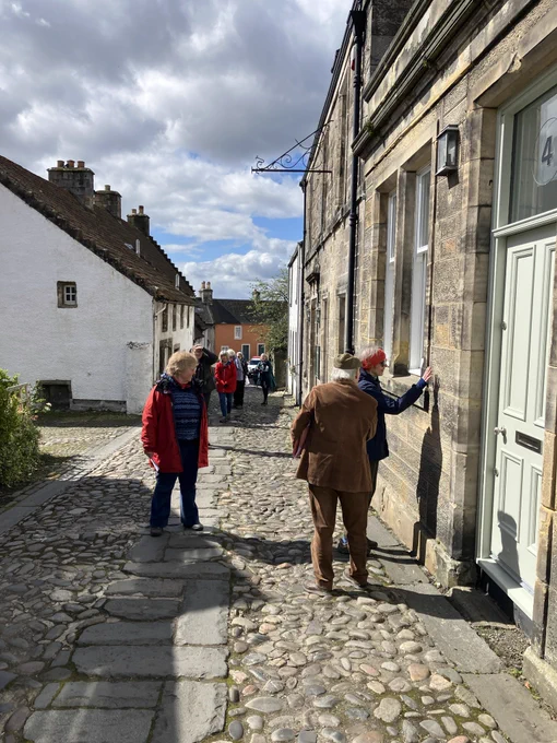 People examine a house in Culross.