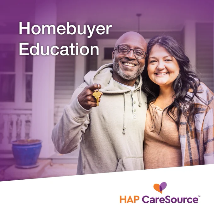 Two smiling individuals stand together on a porch, one holding a key. The background shows a home entrance. Text reads "Homebuyer Education." The HAP CareSource logo is visible at the bottom.