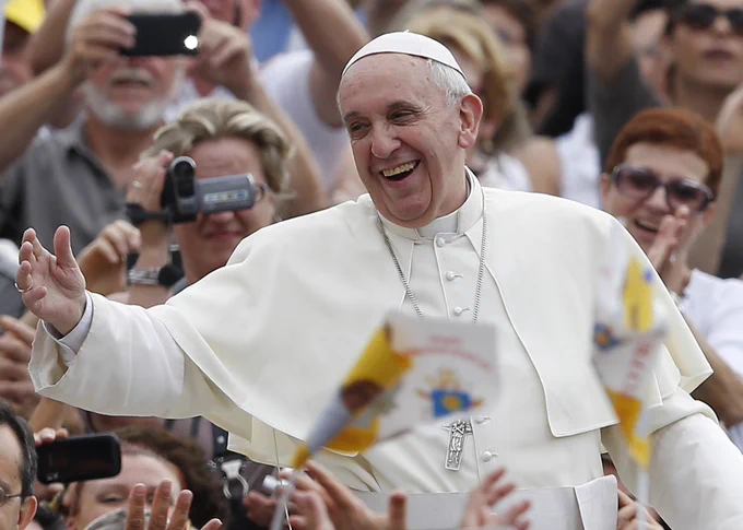 Pope Francis greets the crowd as he arrives to lead his general audience in St. Peter's Square at the Vatican Sept. 11, 2013. (CNS photo/Paul Haring) 