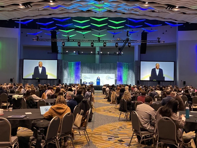 Jay Inslee, Former Governor of Washington, stands a podium speaking to audience at the MI Healthy Climate Conference
