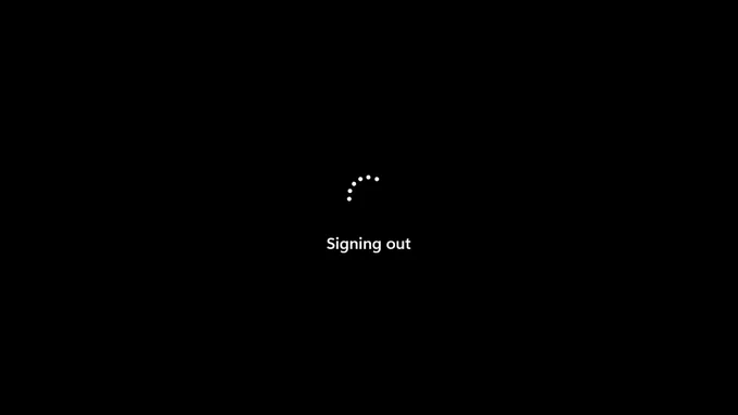 Windows 11 signing out screen, with old Windows 8-style spinning dots above the text.