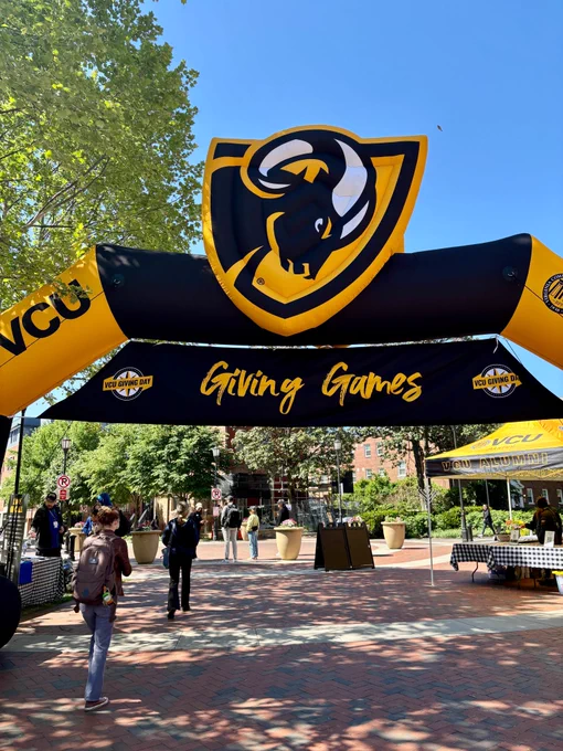 A large black and gold inflatable outdoors with the V-C-U Ram logo and the words "Giving Games."
